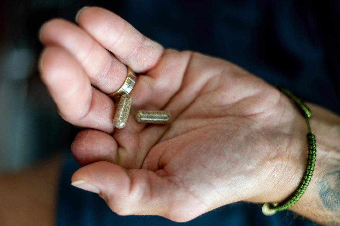 Jose Martinez holds microdose capsules of psilocybin mushrooms he uses as a sleep aid and pain reliever.