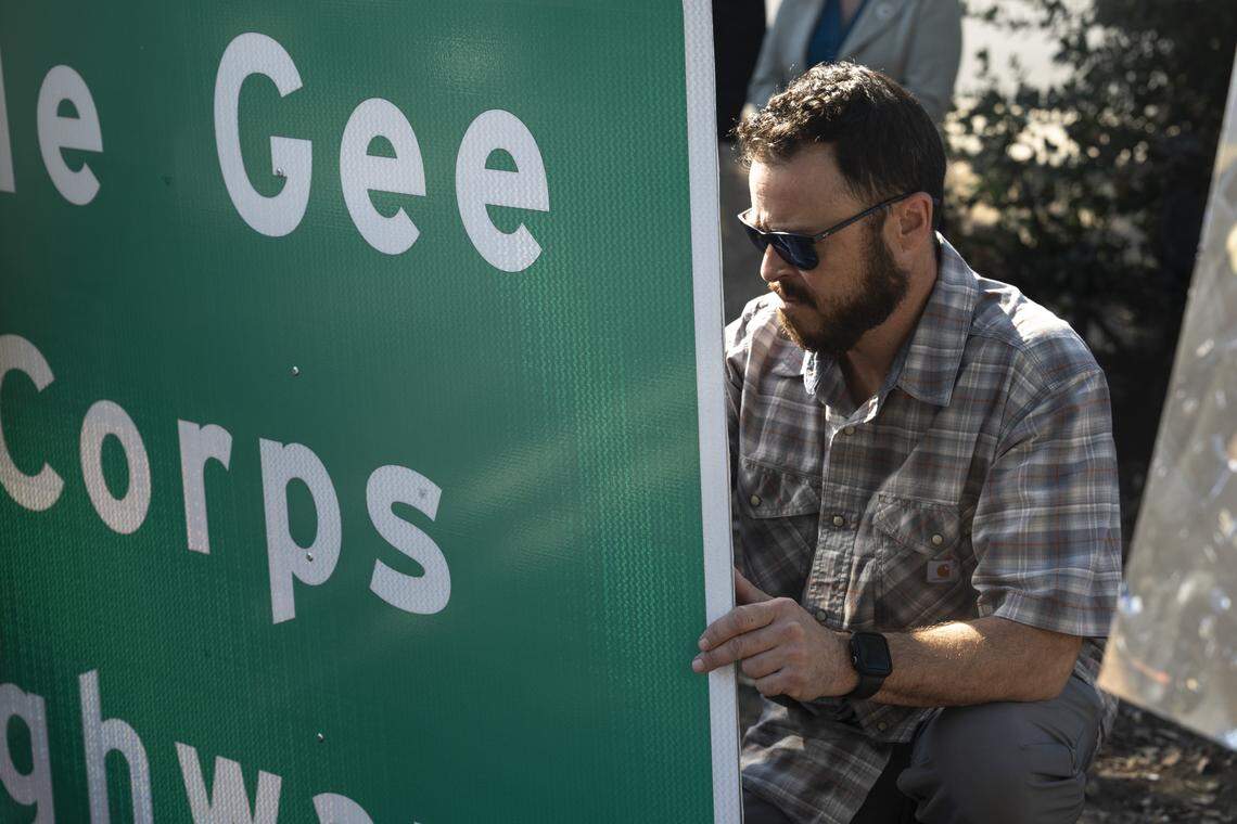 Friends and relatives signs the back of a highway sign designating the portion of Interstate 80 as the "Sergeant Nicole Gee U.S. Marine Corps Memorial Highway" during a dedication ceremony in Roseville on Wednesday. 