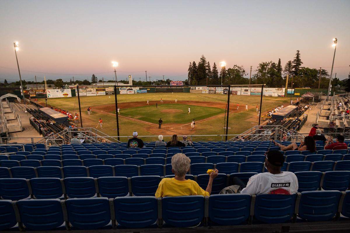 Joan Saunders, left, and husband Sandy Saunders, both of Marysville, cheer the Yuba-Sutter Gold Sox as they play the Lincoln Potters on Thursday, July 9, 2020, at Colusa Casino Stadium in Marysville. “Normally they a have a bigger section, this is the cheering section up here, the horn section, horns and bells and everything else” Sandy said, as his wife added, “oh yeah, its a shame this year.” The team has found a way to have their season amid coronavirus-prevention restrictions by conducting temperature checks upon arrival, requiring facial coverings for entry and limiting seating to 100 fans per game while spacing seating to maintain social distancing.