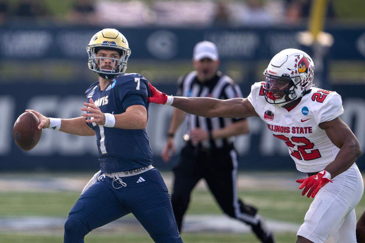 UC Davis Aggies quarterback Miles Hastings (7) scrambles away from Illinois State Redbirds linebacker Amir Abdullah (22) in the first half of the FCS second-round playoff game Saturday, Dec. 7, 2024, in Davis.