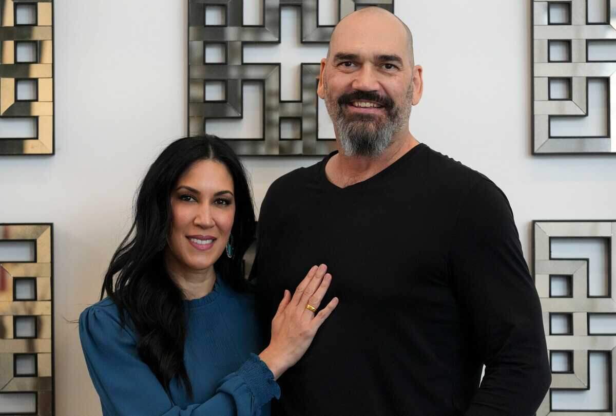 Former Sacramento Kings player Scot Pollard and wife Dawn Pollard stand in their home in Carmel, Ind., in December. Scot Pollard received a heart transplant earlier in the year. 