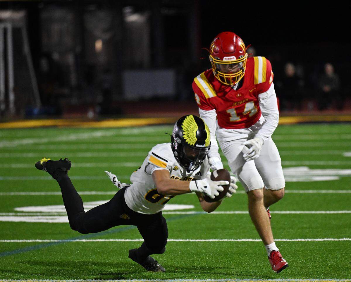The Del Oro Golden Eagles' Chase Carmazzi (80) intercepts a pass intended for the Jesuit Marauders' Stevie Hughes (14) late In the second half on Friday, Oct. 17, 2025, in Carmichael.