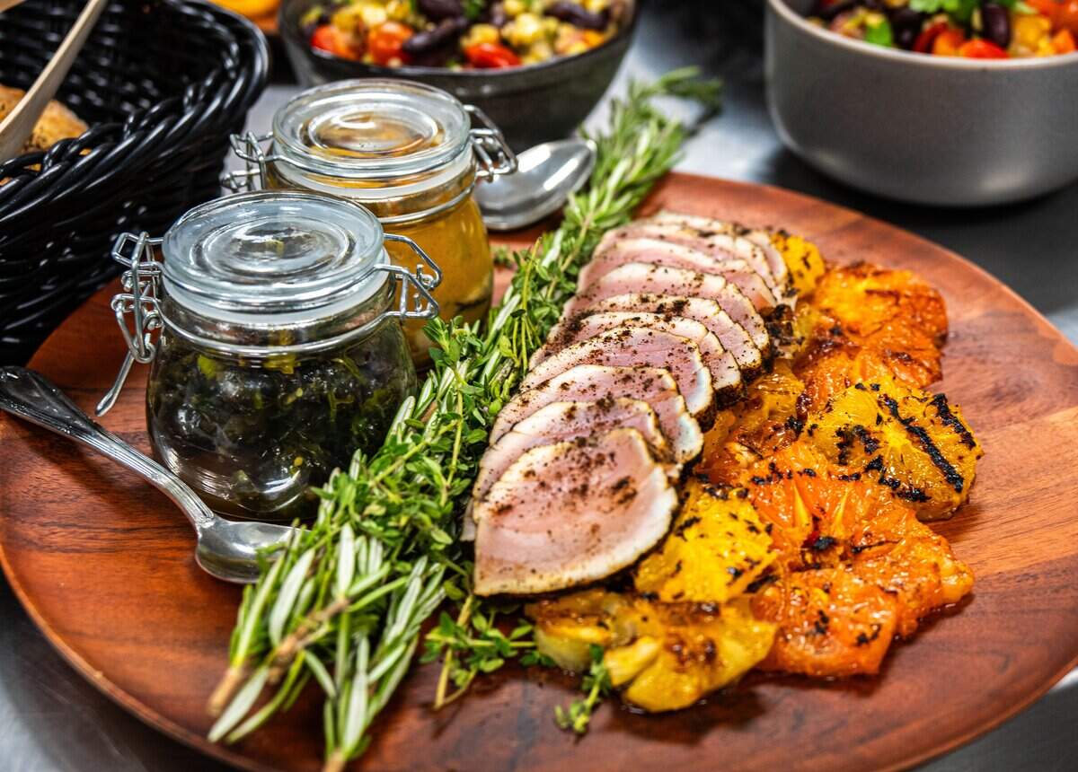 One of the courses for the Tower Bridge Dinner — ash-crusted albacore tuna with heirloom bean succotash, smoked mussels and clams, California seaweed salad, and furikake crackers — is presented during a preview for the exclusive dinner in August.