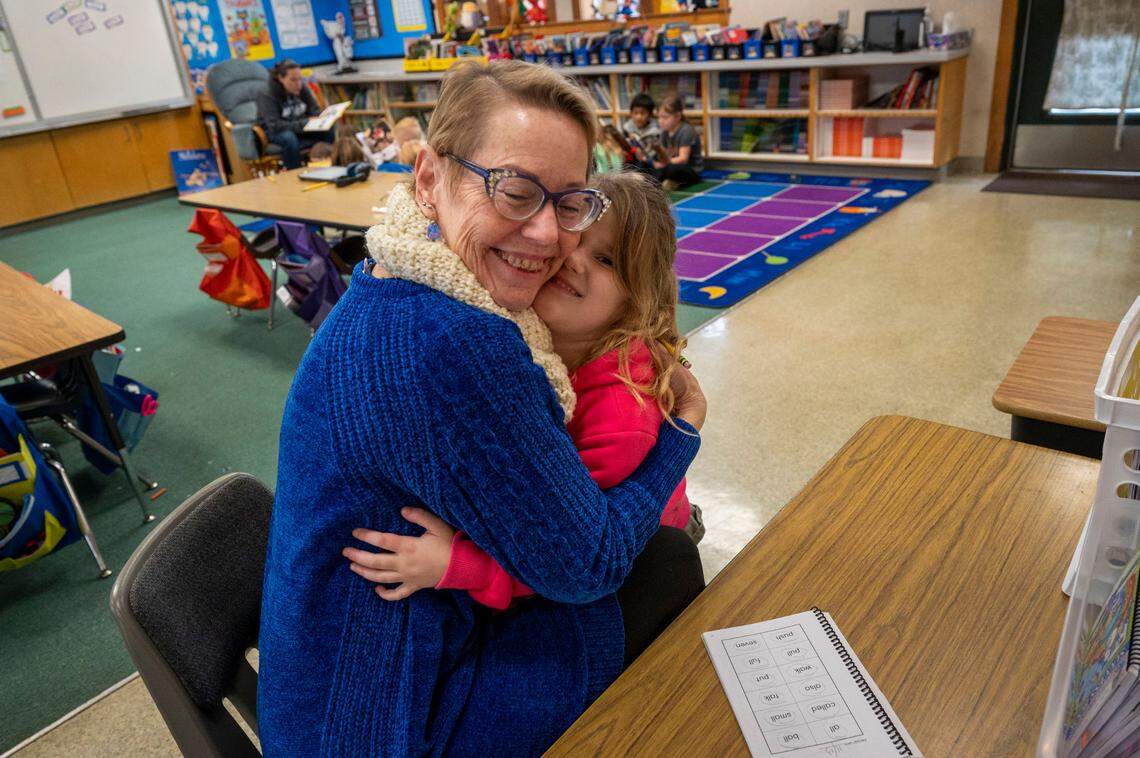 Lysa Sassman, a volunteer with Sight Word Busters, gets a hug from Scarlett after working with her one-on-one at Sierra Hills Elementary School in Meadow Vista earlier this month.