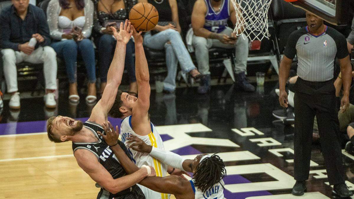 Sacramento Kings center Domantas Sabonis (10) battles Golden State Warriors guard Klay Thompson (11) for a rebound during Game 2 of the first-round NBA playoff series at Golden 1 Center on Monday, April 17, 2023.