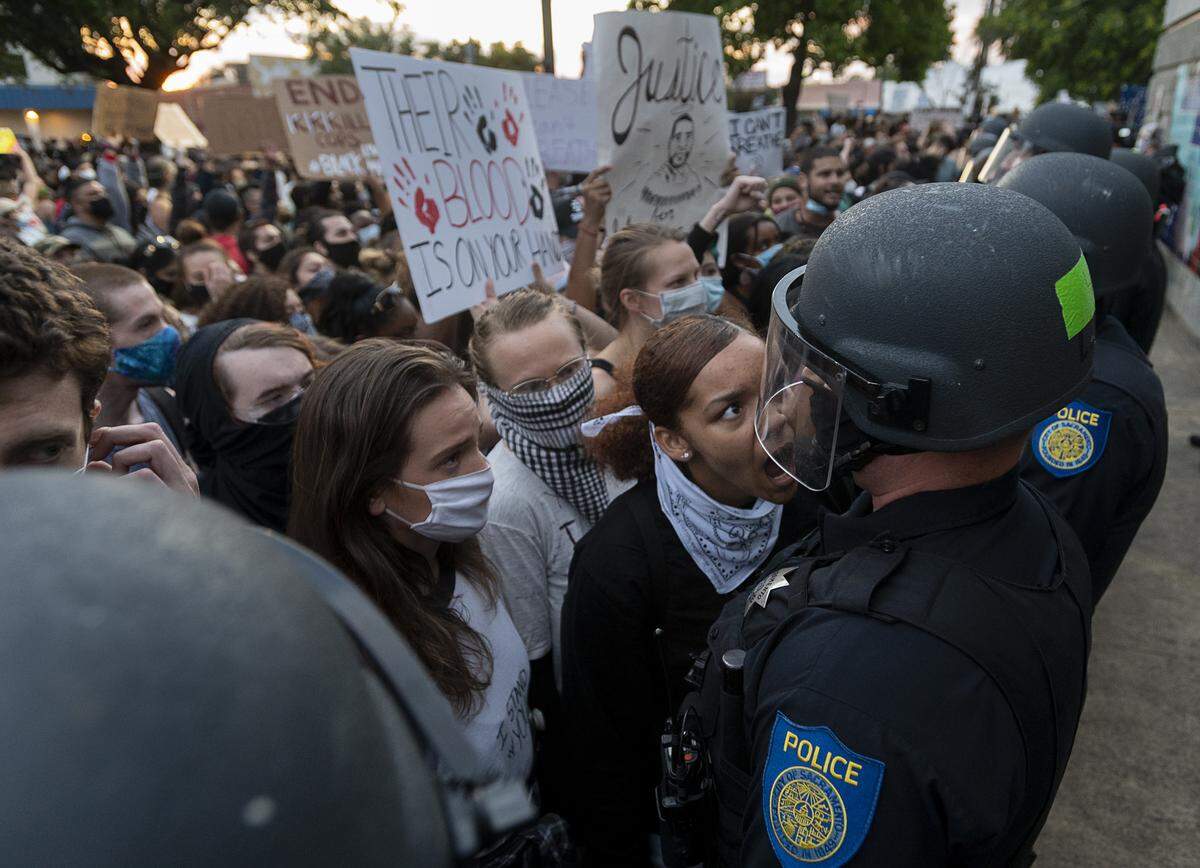 Demonstrators face off with Sacramento Police officers during a protest organized by Black Lives Matter Sacramento over the death of George Floyd on Friday, May 29, 2020, in Sacramento during the coronavirus pandemic. Floyd died in Minneapolis on May 25 after being detained by police.