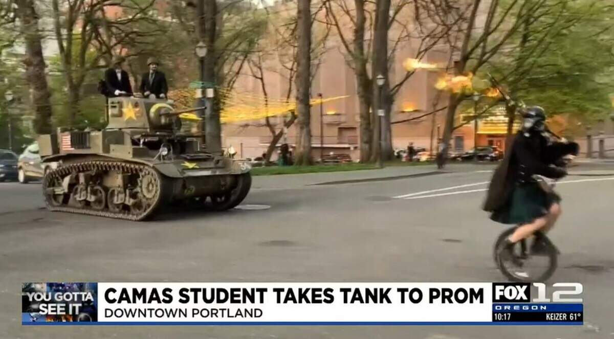 Teens are accompanied by a flaming bagpipe player on their way to prom.