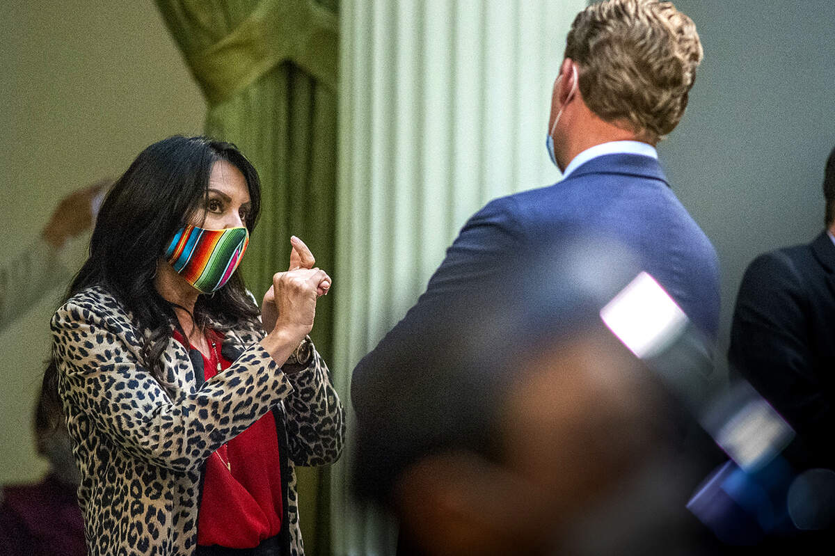 Assemblywoman Blanca Rubio, D-Baldwin Park, talks with Assemblyman Chad Mayes, I-Yucca Valley, during the last session on the Assembly floor in Sacramento in August 2020. Rubio in 2020 became the leader of an informal moderat Democratic caucus known as the “New Democrats.”
