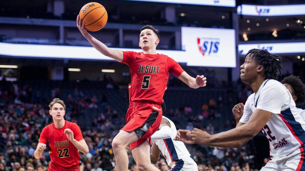 Jesuit Marauders guard Kevin Haupt (5) makes a layup past Modesto Christian Crusaders forward Kodey Weary (22) in the CIF Sac-Joaquin Section Division I boys basketball championship game at Golden 1 Center last year.