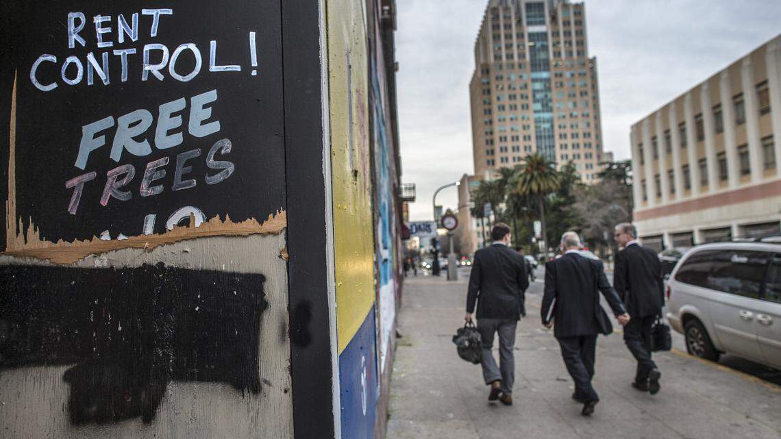 Pedestrians walk past a vacant building on J Street.