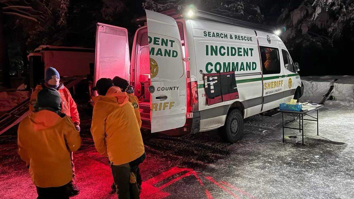 Emergency responders gather near incident command vehicles in a snowy staging area near Castle Peak in Nevada County, Calif., on Monday after an avalanche killed a snowmobiler in the backcountry.