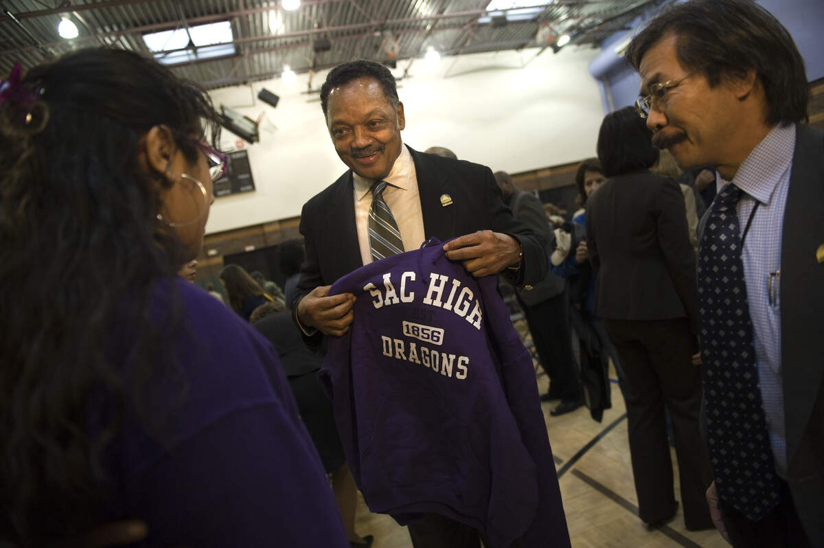 Rev. Jesse Jackson smiles after he was given a Sacramento High sweatshirt at the Sacramento Boys and Girls club on March 2, 2009. He joined Mayor Kevin Johnson was joined to launch "Volunteer Sacramento," designed to boost volunteerism in the community, and make it the leading city in California for those efforts.