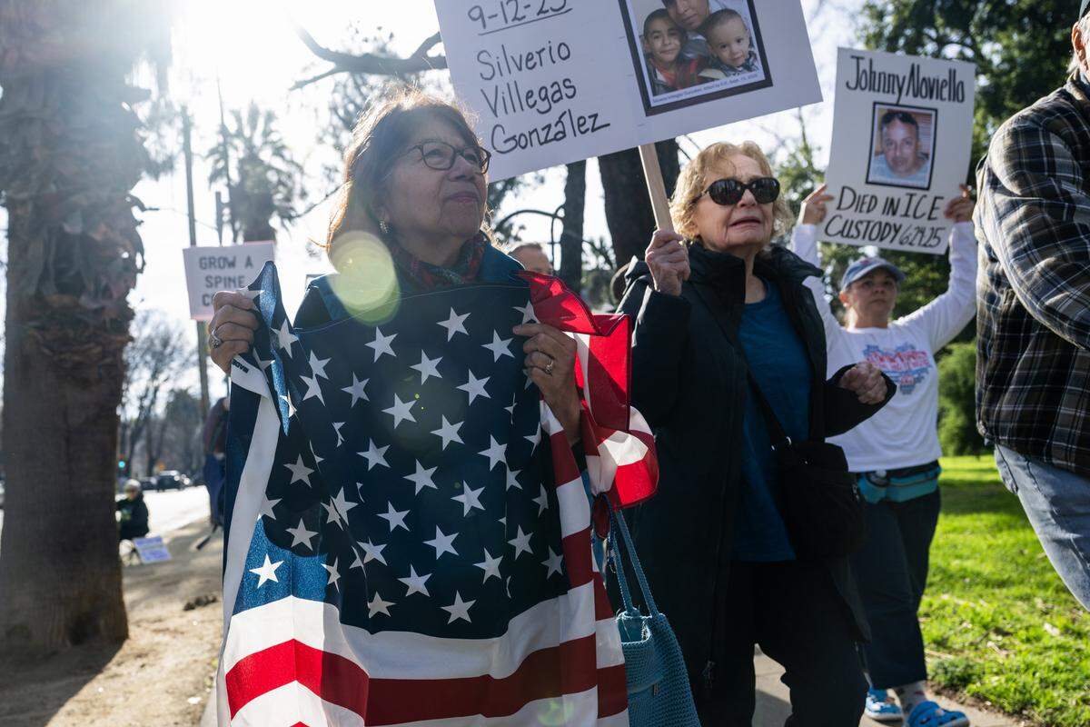 Gregoria Miranda, left, and Carol Wallisch march from Capitol Park to Memorial Auditorium in Sacramento during an “ICE Out For Good” demonstration on Saturday after a U.S. Immigration and Customs Enforcement officer in Minneapolis killed Renee Nicole Good earlier in the week.