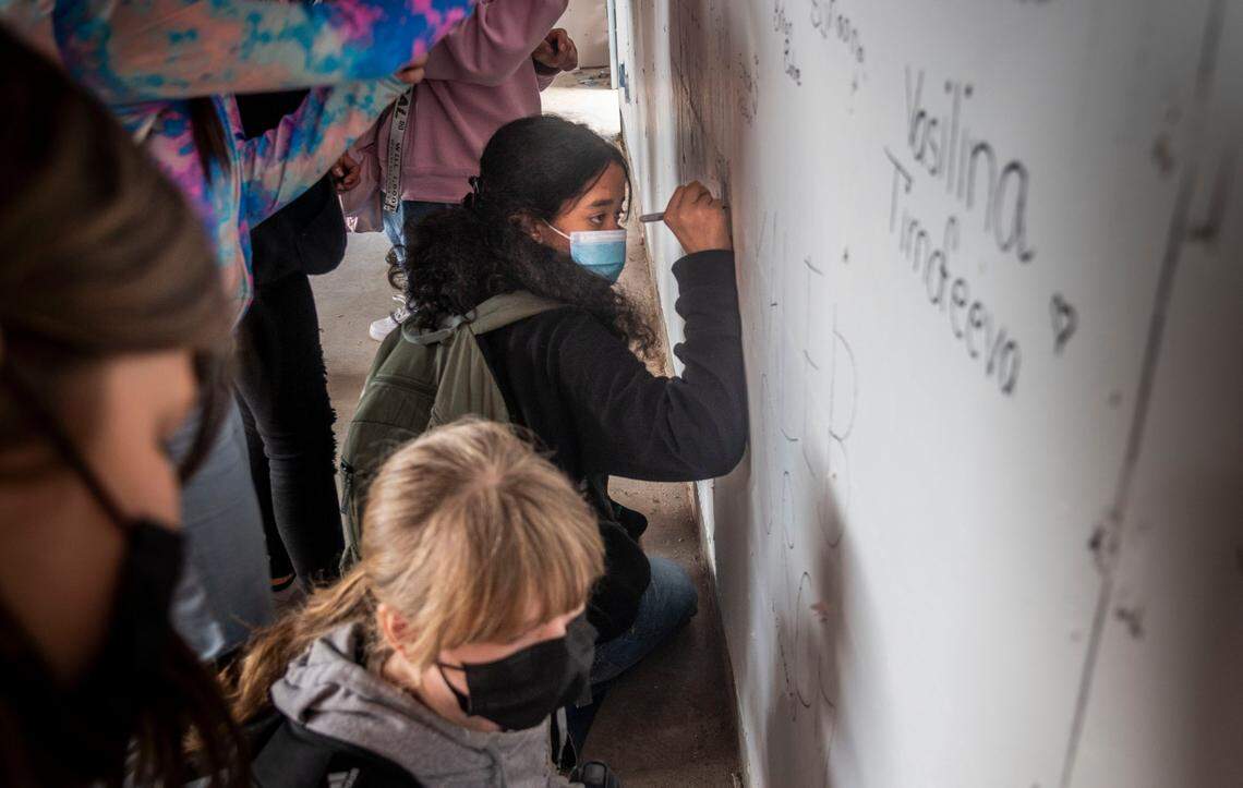 Students at Barrett Middle School in Carmichael sign their names on the wall of a new music room, part of a series of campus upgrades to the San Juan Unified School District school, in February. The district’s November school board races featured the most extreme example of a far-right candidate seeking office.