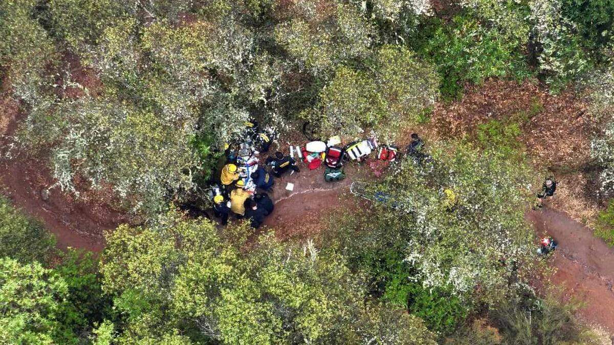 Cal Fire and Placer County Fire Department firefighters provide medical treatment to a 45-year-old man on the Connector Trail in Placer County Saturday. 