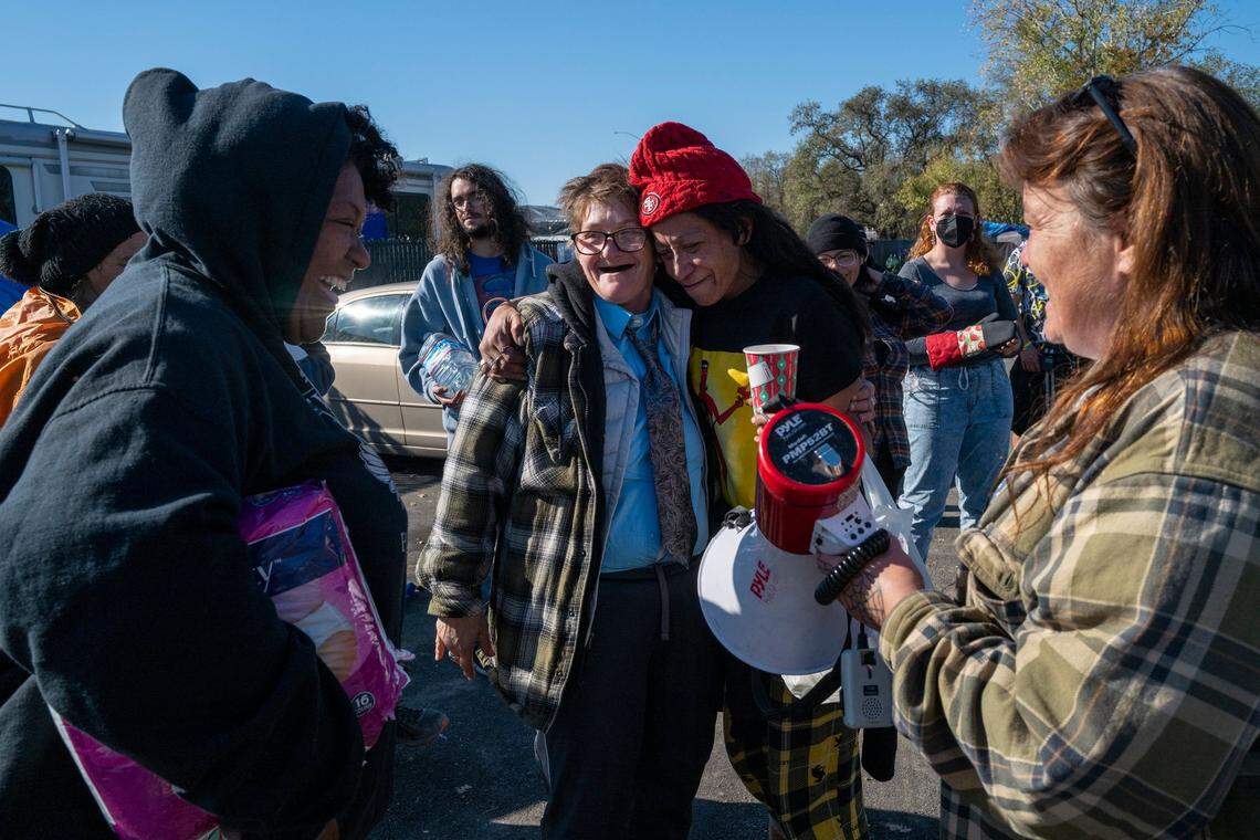 Camp Resolution residents Joyce Williams and Desiree Pryor embrace Wednesday, Nov. 16, 2022 after Tammy Tyler, right, thanked everyone that spoke up at Tuesday’s Sacramento City Council meeting. The council unanimously passed a motion, not on the agenda and technically nonbinding, to postpone removing the homeless encampment at Arden Way and Colfax street in North Sacramento.