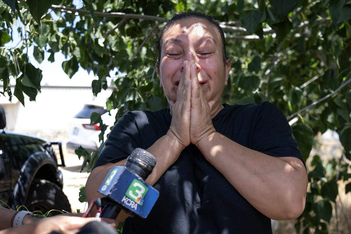 Marisol Ramos weeps Thursday, July 3, 2025, as she waits for news of her children, missing since the fireworks explosion in a warehouse in Esparto two days before. 
