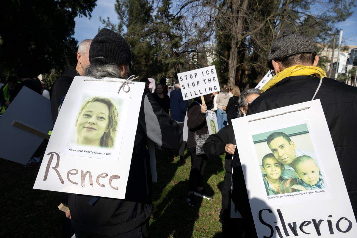 Protesters carry pictures of people killed by ICE agents as they march from Capitol Park to Memorial Auditorium in Sacramento on Saturday after a U.S. Immigration and Customs Enforcement officer in Minneapolis killed Renee Nicole Good earlier in the week. A picture of Silverio Villegas-Gonzalez, slain in September, accompanies a photo of Good.