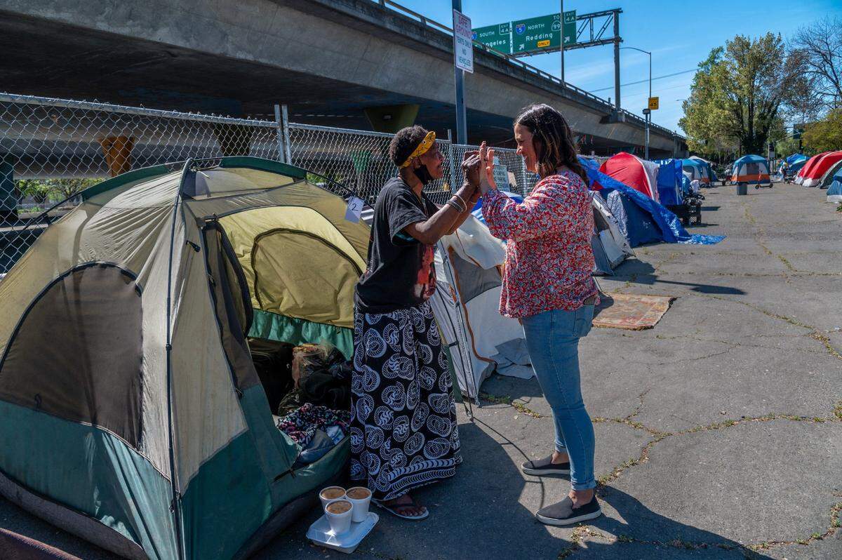Jenny Jordan, right, program supervisor with First Step Communities, celebrates with Shari Spikes, 59, after helping her move into a homeless encampment at the W-X Safe Ground lot on Wednesday, April 7, 2021. I am overwhelmed with the love of everyone pouring down on me. I didnt think anybody cared but of course they care, said an emotional Spikes.