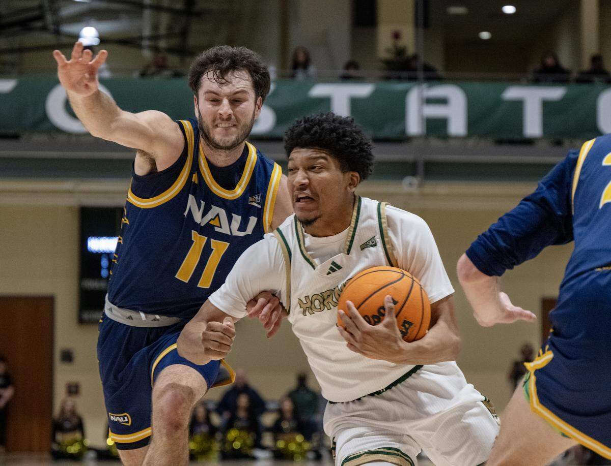 Sacramento State Hornets guard Jayden Teat (5) drives past Northern Arizona Lumberjacks guard Ryan Abelman (11) in the first half on Thursday, Jan. 15, 2026, in Sacramento.