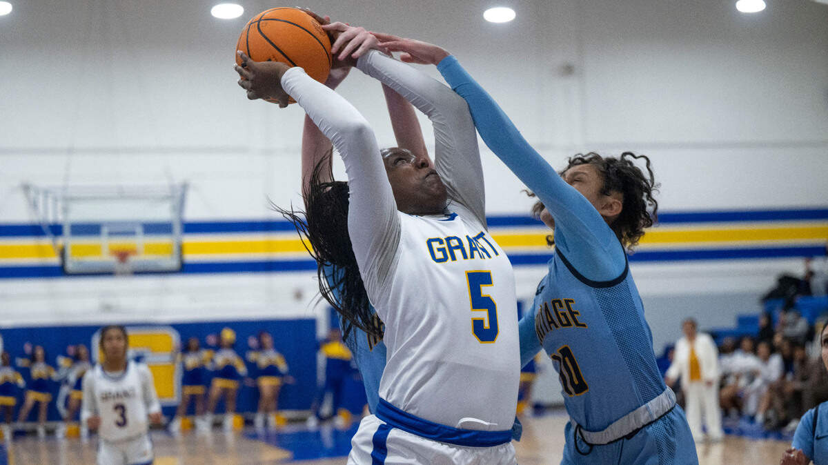 The Grant Pacers’ Samaya Dillard (5) is fouled as she shoots past Heritage High School defenders in a first-round CIF Northern California regional Division III girls basketball playoff game Tuesday in Del Paso Heights. The Pacers, seeded sixth in the tournament, lost 54-40.