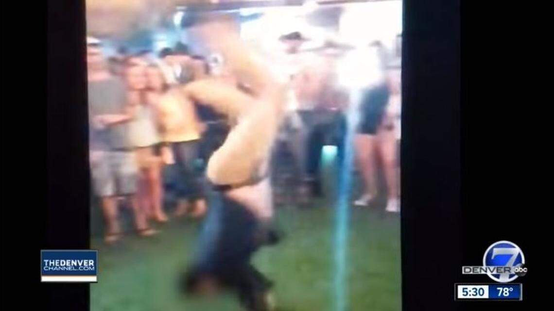 An off-duty FBI agent performs a backflip early June 2 at a Denver bar in a video obtained by KMGH. A handgun falls from the man's waistband holster and fires as he tries to pick it up, injuring a bystander.