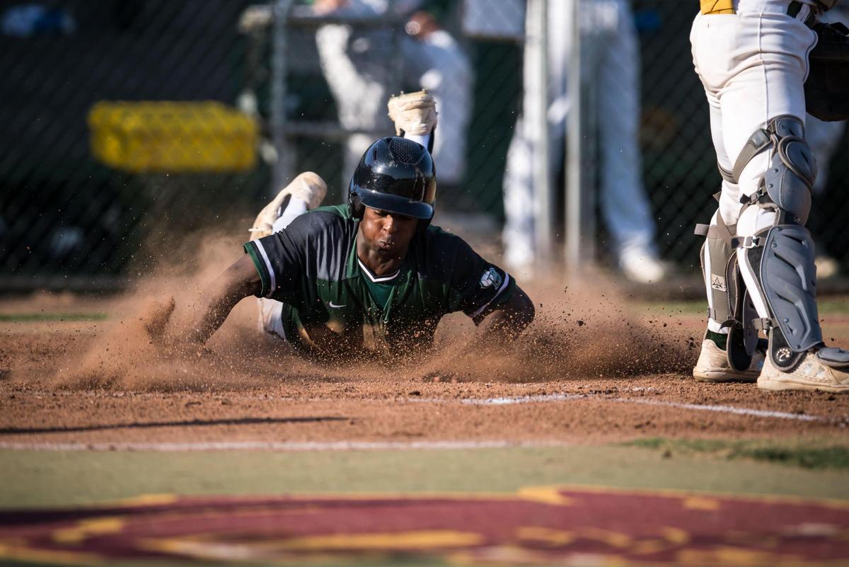 Granite Bay Grizzlies outfielder Timmy Reed (3) slides into home to score past Rio Americano Raiders catcher Jonathan Pierce (23) on a single from Cody Ferrante (9) in the first inning of the CIF Sac-Joaquin Section Division II high school baseball championship game Thursday, May 25, 2023, at Sacramento City College. The Grizzlies beat the Raiders for the title for the second year in a row.