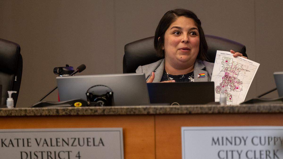 Katie Valenzuela holds up a map that had been projected during a Sacramento City Council meeting on homeless explaining there is no place for the homeless to go in the city on Tuesday, June 27, 2023.