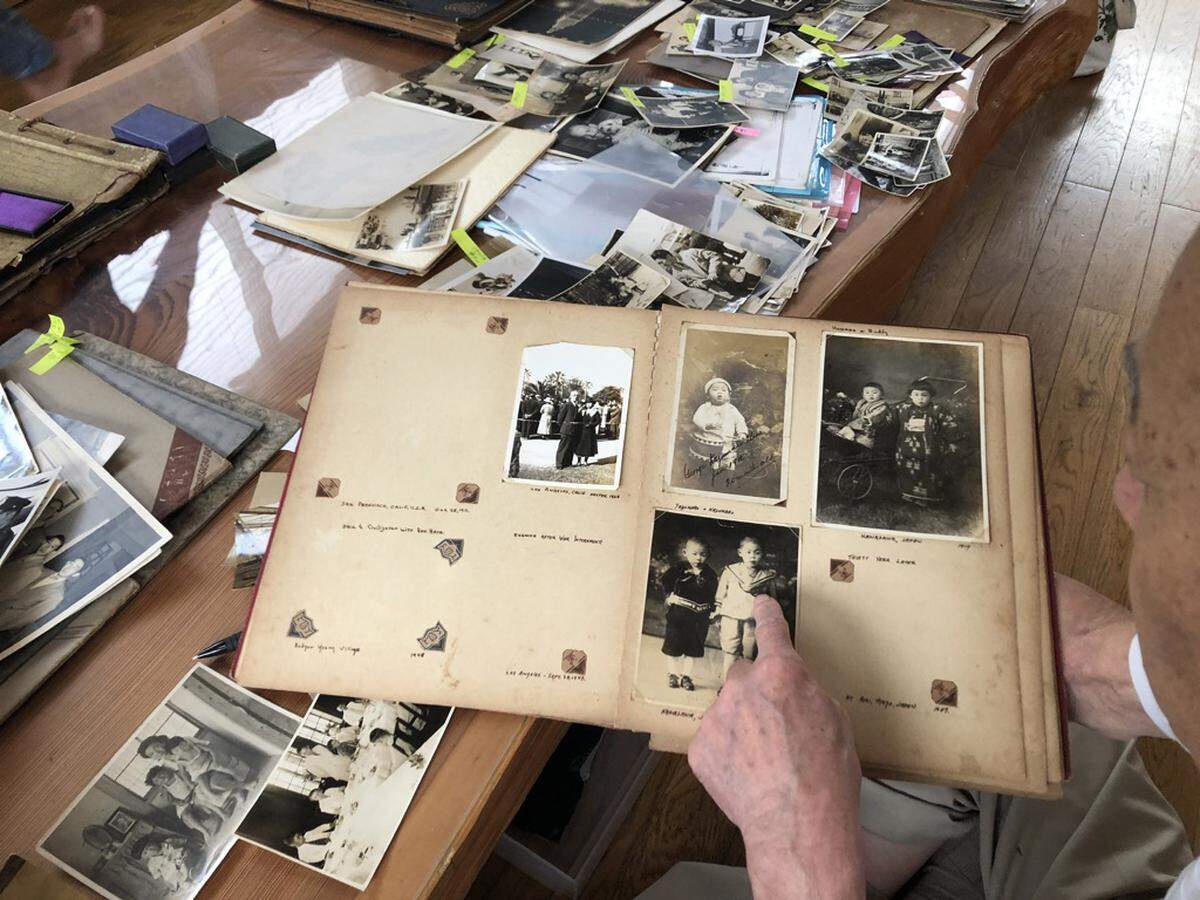 George Uno looks through archives at home in Japan. The five-hour documentary series “Asian Americans” is airing on PBS through June 8.