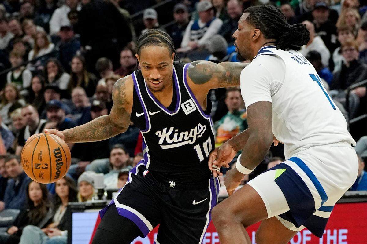 Sacramento Kings forward DeMar DeRozan (10) goes around Minnesota Timberwolves center Naz Reid (11) in the fourth quarter Monday, Feb. 3, 2025, at Target Center in Minneapolis, Minnesota.