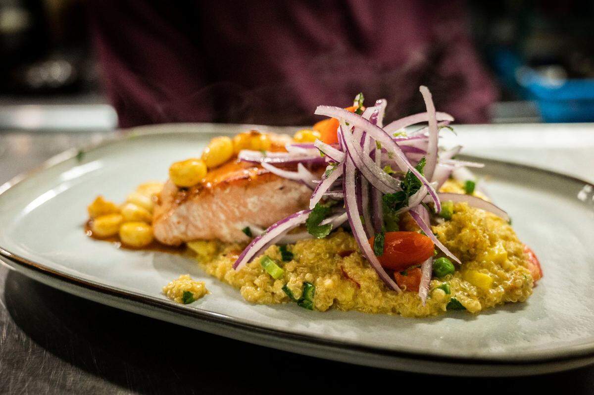 Salmón Andino, is grilled salmon bathed in anticuchera sauce, on a bed of quinoa cooked with ají Amarillo and Peruvian corn at Chicha Peruvian Kitchen in Roseville on Thursday, Feb. 10, 2022.
