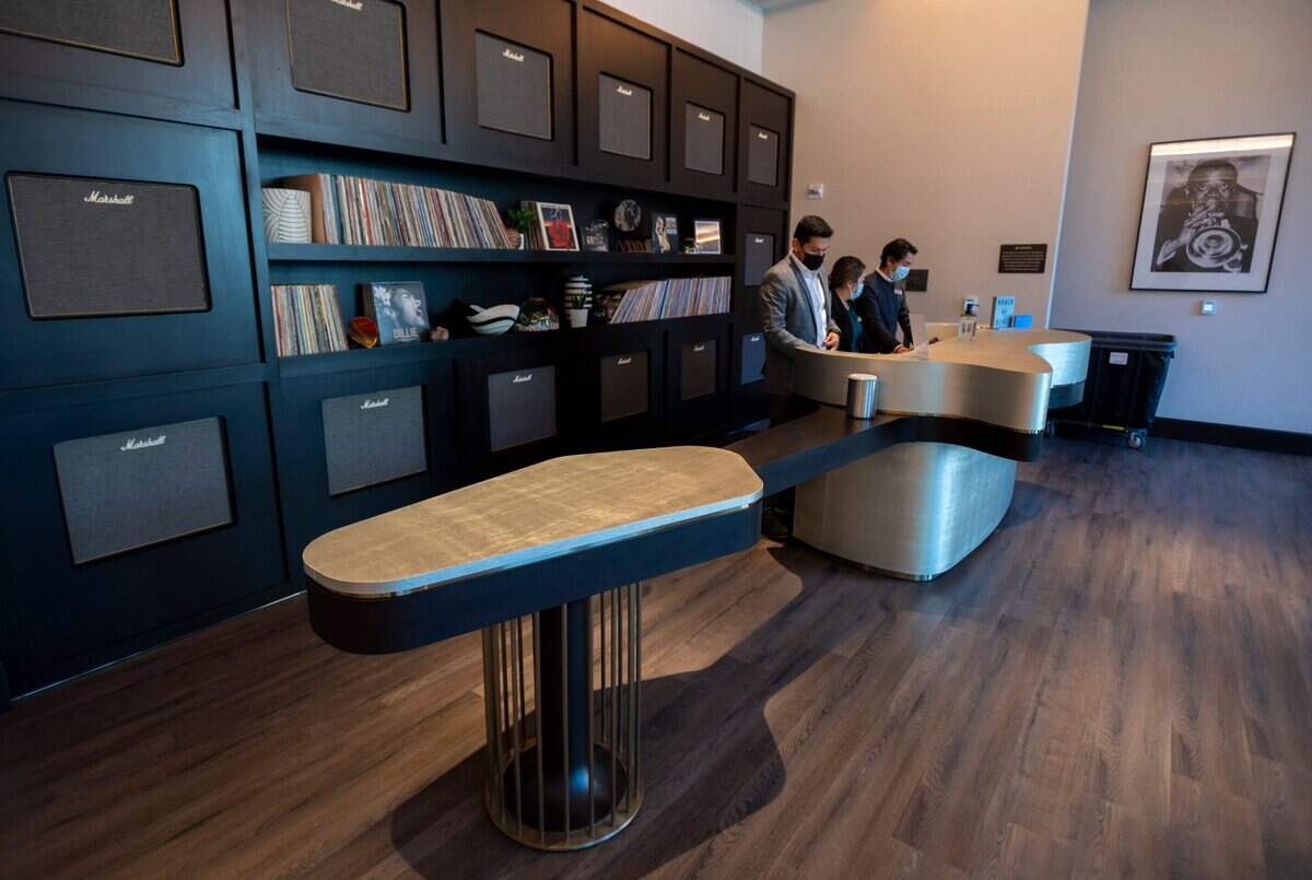 The front desk in the lobby at the Hyatt Centric Downtown Sacramento is shaped like a guitar to pay homage to the jazz era at the former Hotel Clayton. Marshall guitar amplifiers form a background with LP records behind the front desk.
