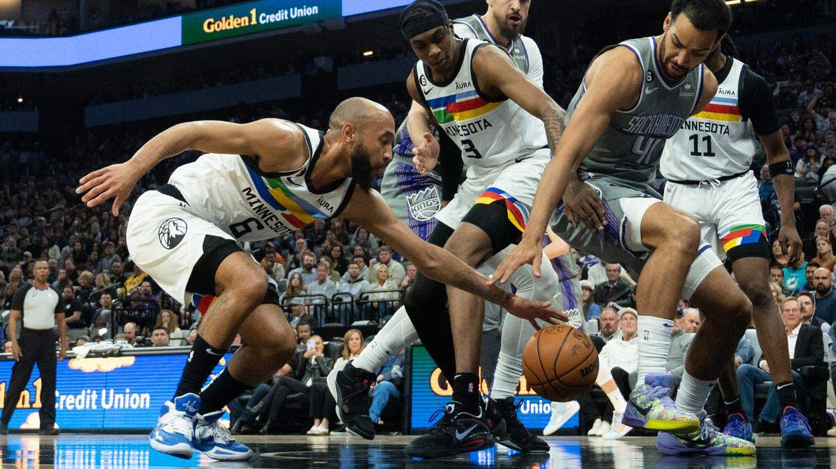 Sacramento Kings forward Trey Lyles (41) battles Minnesota Timberwolves guard Jordan McLaughlin (6) and Minnesota Timberwolves forward Jaden McDaniels (3) in the second quarter during a game at Golden 1 Center in Sacramento, Monday, March 27, 2023.
