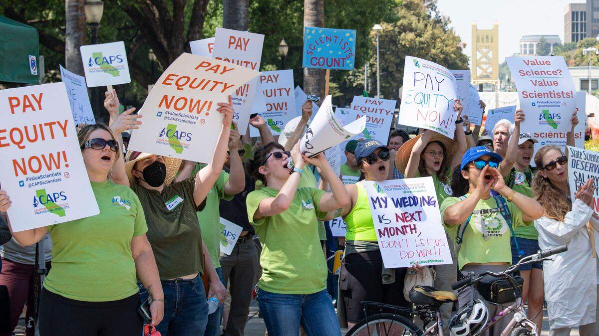 Members of the California Association of Professional Scientists rally for increased wages at the Capitol on Wednesday. The union represents 5,300 scientists that work for the state of California. Its labor agreement expired in 2020, and the group maintains that salaries for its workers have lagged behind managers, supervisors and state engineers by 30%.