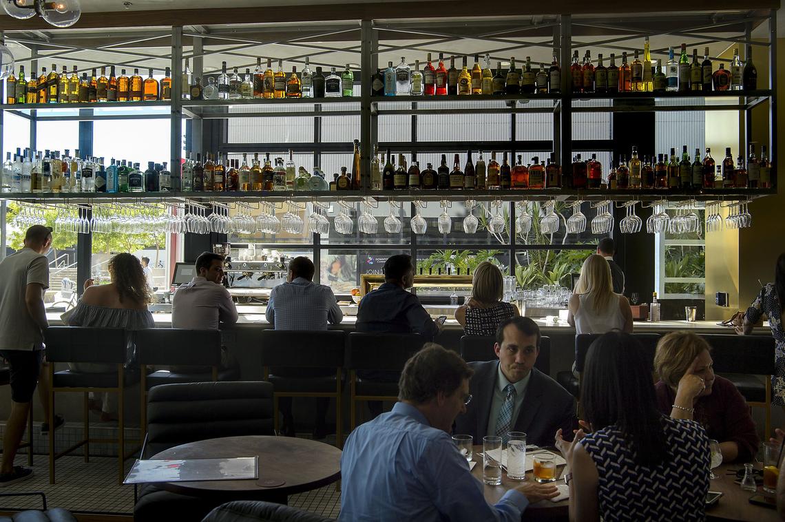 Patrons enjoy the bar at the recently opened Echo & Rig Butcher Steakhouse in downtown Sacramento on Tuesday, July 17, 2018.