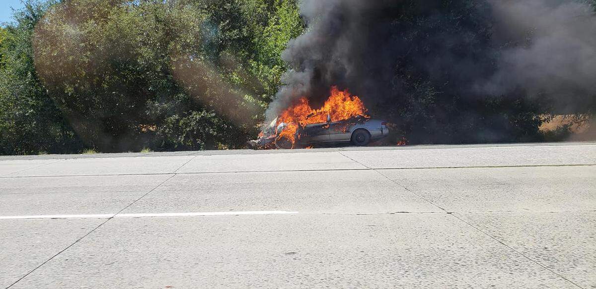 The driver of this sedan, which was choked with flames on the I-80 near Citrus Heights, was arrested for driving under the influence.