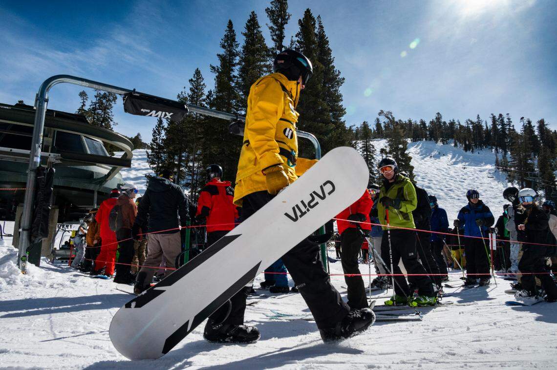 A Heavenly staff member walks past the line to board the Sky Express lift on the California side of the resort earlier this month.