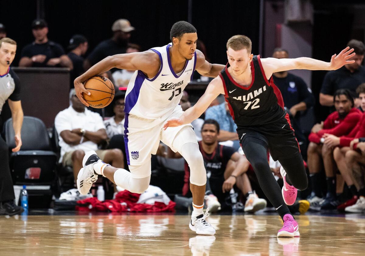 Sacramento Kings forward Keegan Murray (13), left, dribbles the ball behind his back past Miami Heat guard Justin Powell (72) after a recovering a block by Kings forward Jalen Slawson (18) during the second half of their California Classic NBA summer league basketball game Wednesday, July 5, 2023, at Golden 1 Center.