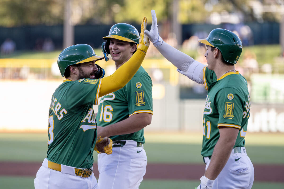 Athletics catcher Shea Langeliers (23) is greeted by teammates Nick Kurtz (16) and Tyler Soderstrom (21) after hitting a two-run home run in the bottom of the first inning off Arizona Diamondbacks pitcher Anthony DeSclafani (21) at Sutter Health Park on Friday, Aug. 1, 2025, in West Sacramento.