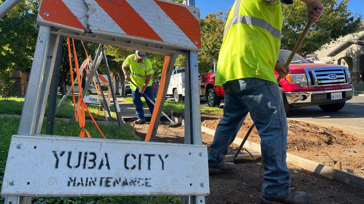 Yuba City maintenance division worker Jose Velero, left, levels the ground alongside Ryan Armore while repairing a sidewalk on Ross Drive on Thursday, Sept. 19, 2024.  City officials discussed possible cuts across all departments while broaching another tax measure. 