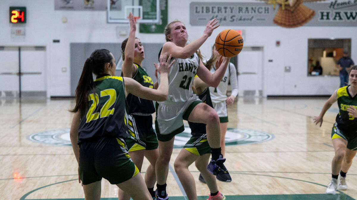 Liberty Ranch’s Haley Smith (21) drives to the basket during a CIF girls basketball playoff game against Sonora at Liberty Ranch High School in Galt on Tuesday.