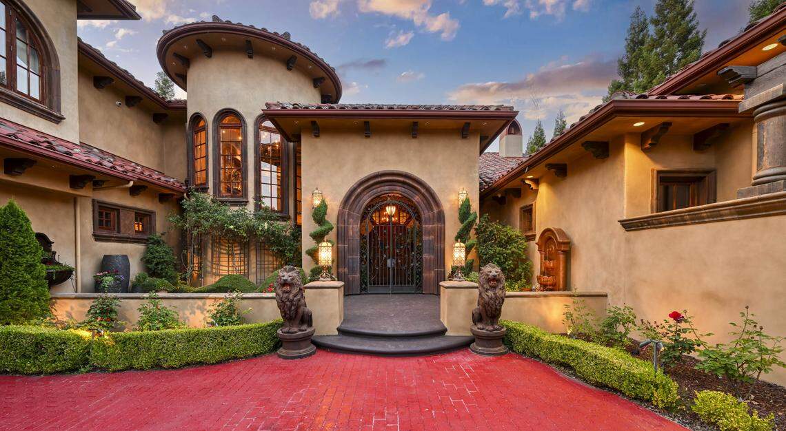 The hand-forged Romanesque entry door and brick surrounding it hint at the artistry found throughout the Loomis, California home.