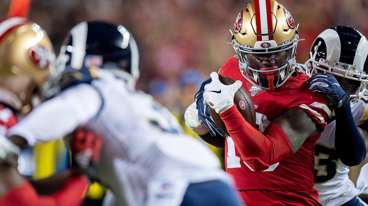 San Francisco wide receiver Deebo Samuel scores a touchdown against the Rams on Saturday night. For more coverage of the showdown, visit sacbee.com.
