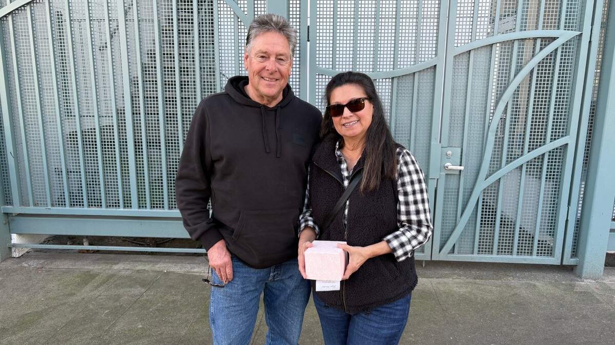 Ron and Barbara Benavidez, who have been married for 39 years, stand near the corner of 24th and J streets in Sacramento on Feb. 10, 2025.