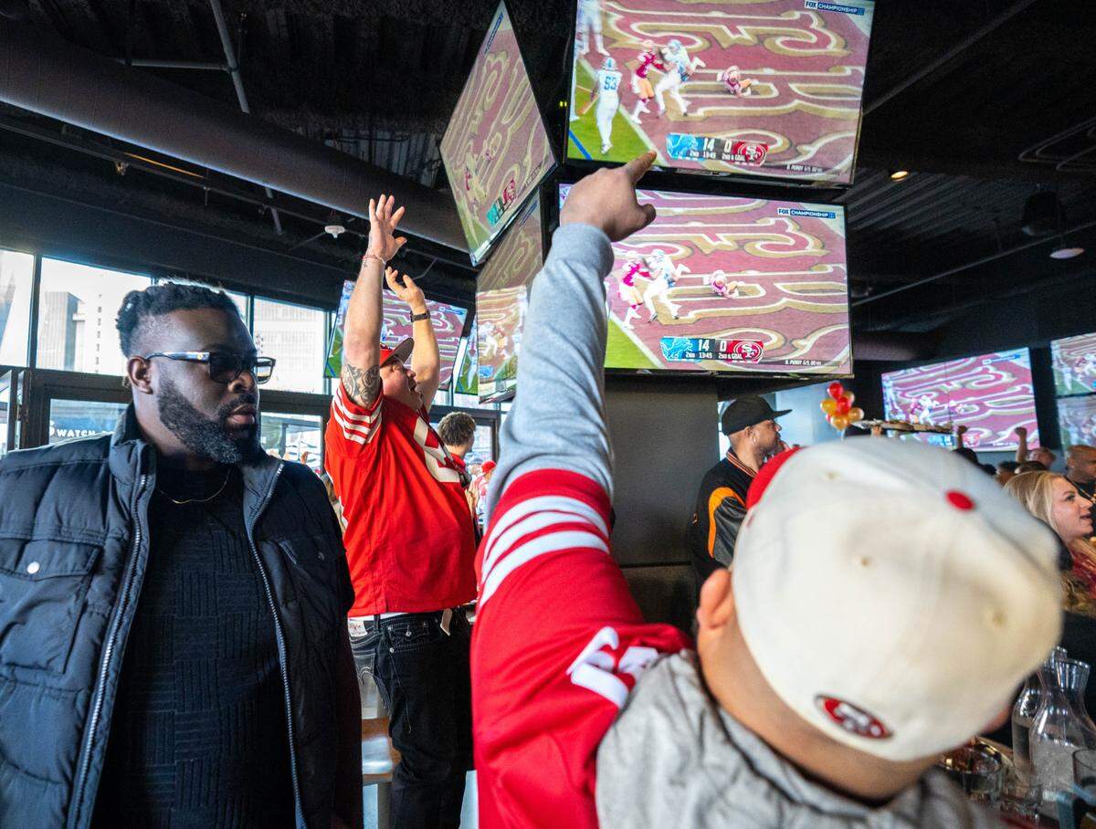 San Francisco 49ers fans celebrate a touchdown during the NFC Championship game watch party at Tom’s Watch Bar on Jan. 28, 2024.