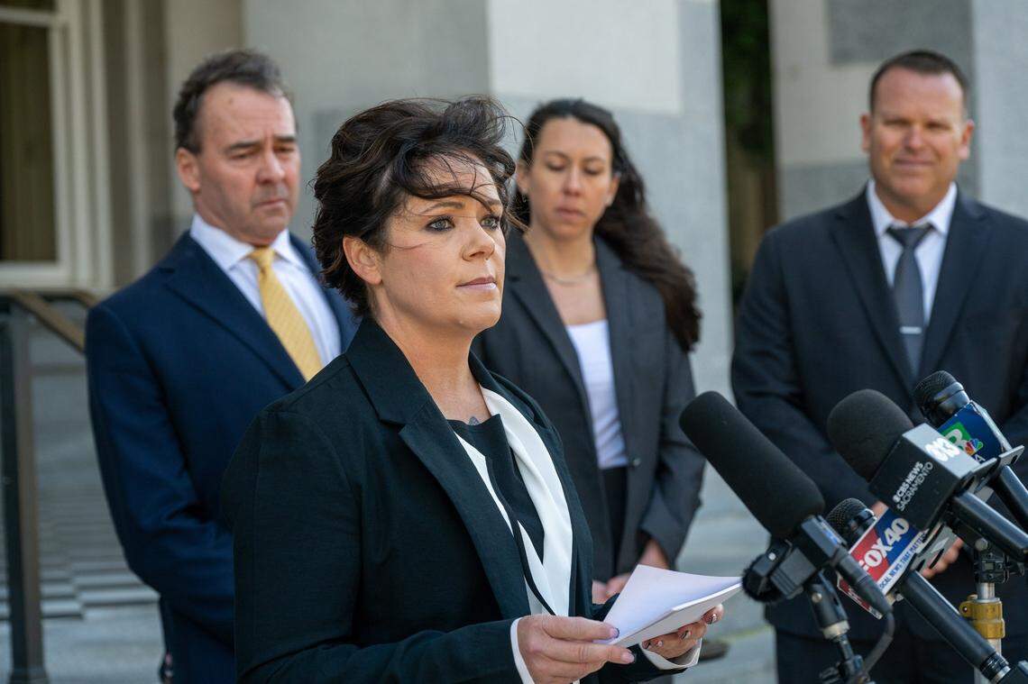 Katie Jackson looks up while reading a statement at a January press conference at the California Capitol, where she described how a prisoner raped her while she was working as a correctional officer at the Department of Corrections and Rehabilitation. “I was strangled, I was held hostage at gunpoint, and I was raped multiple times,” she said.