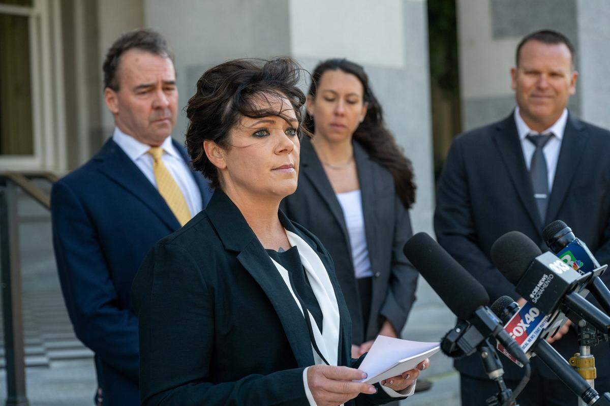 Katie Jackson looks up while reading a statement at a January press conference at the California Capitol, where she described how a prisoner raped her while she was working as a correctional officer at the Department of Corrections and Rehabilitation. “I was strangled, I was held hostage at gunpoint, and I was raped multiple times,” she said.