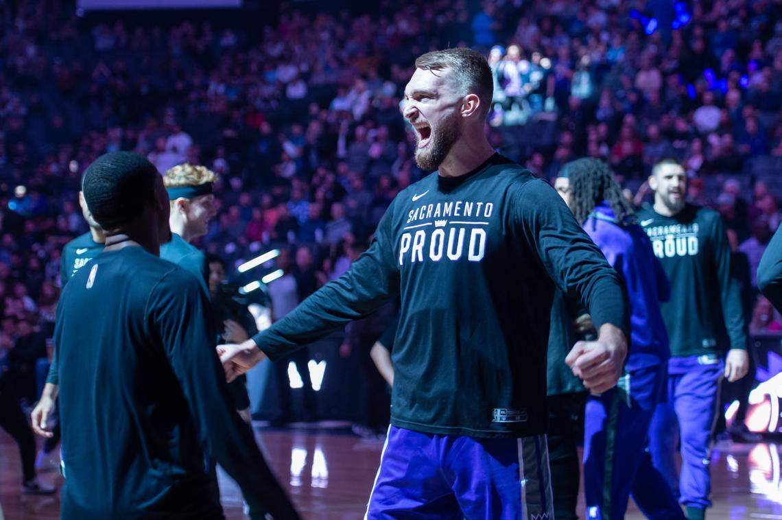 Sacramento Kings guard De’Aaron Fox (5) and forward Domantas Sabonis (10) get pumped up before the game against the Charlotte Hornets on Monday, Dec. 19, 2022, at Golden 1 Center in Sacramento.
