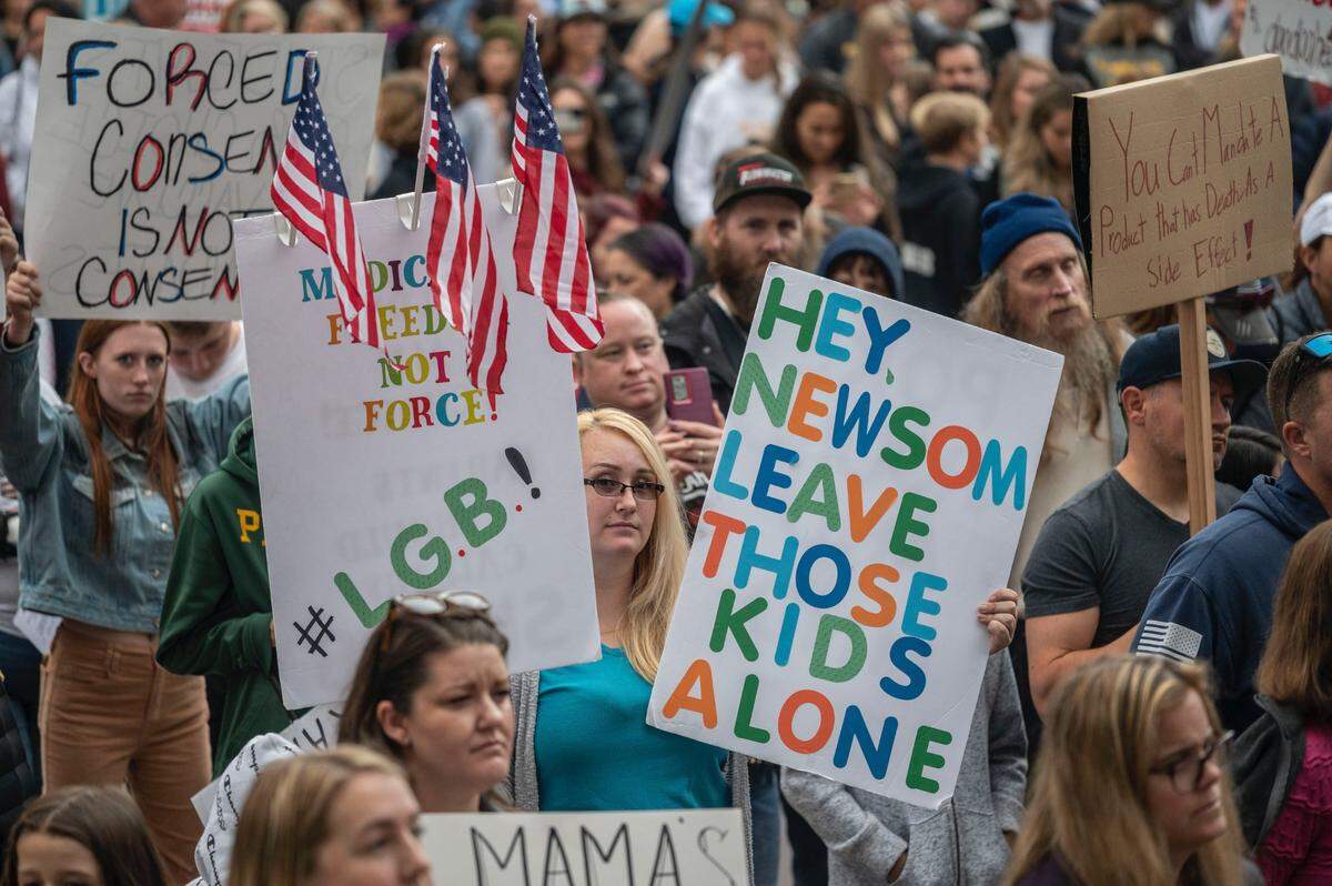 Participants of an “Our Children, Our Choice” rally hold up signs on Nov. 15 on the north steps of the Capitol.