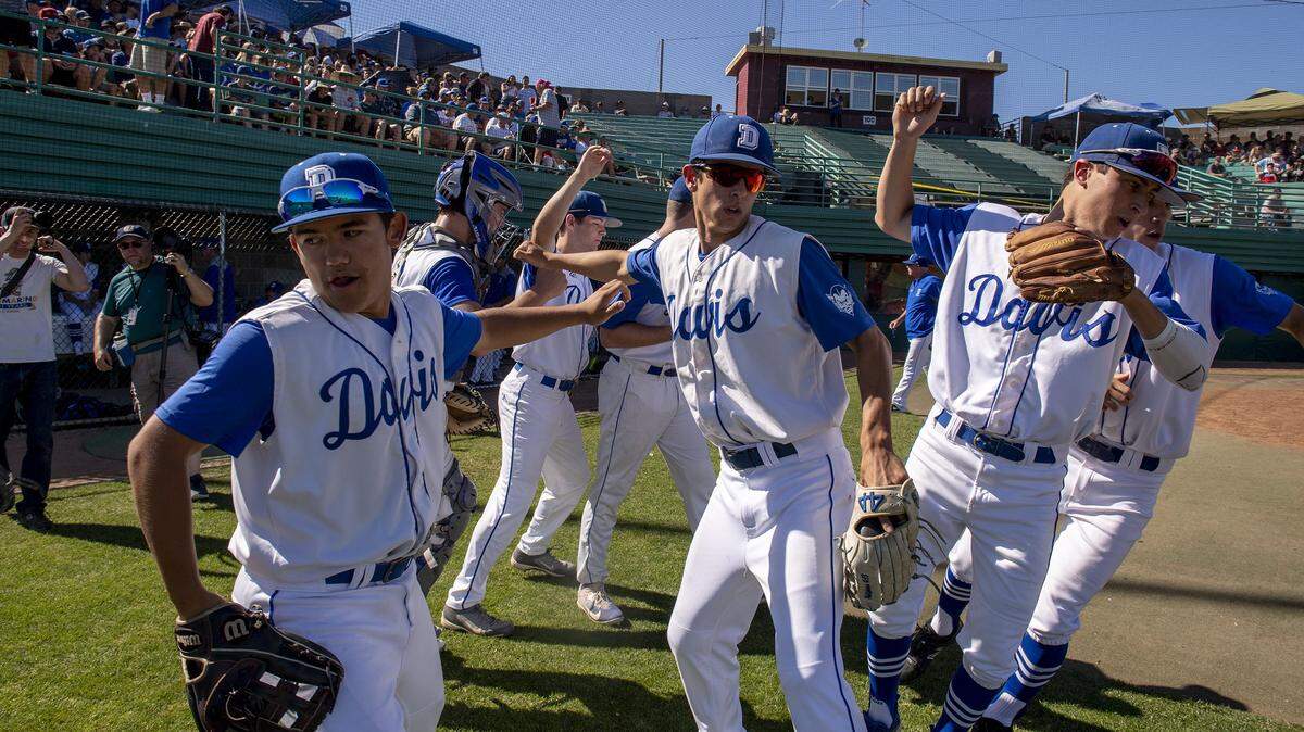 Davis High School Blue Devils take the field against Vacaville in the Sac-Joaquin Section baseball championships at Sacramento City College on May 28, 2018.